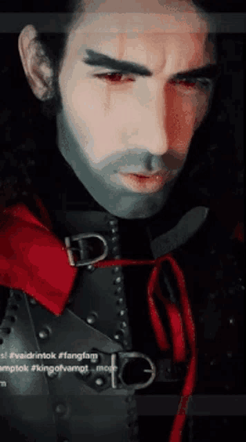 a close up of a man 's face with red eyes
