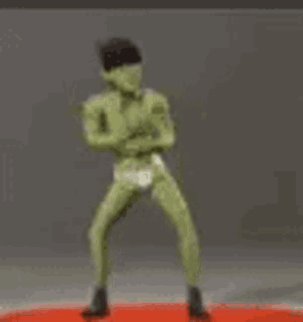 a statue of a man in a white underwear is standing on a red circle .