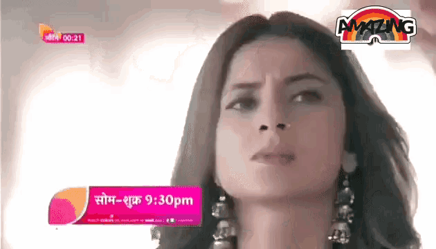 a woman 's face is shown on a tv screen with the time 9:30 pm
