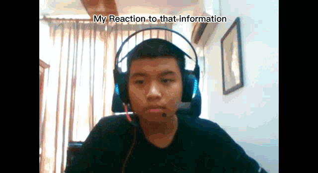 a young man wearing headphones with the words my reaction to that information above him