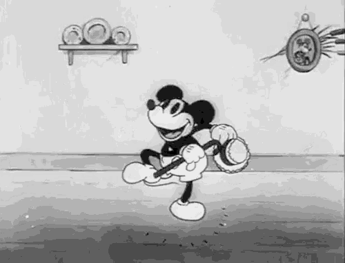 a black and white cartoon of mickey mouse cleaning the floor with a broom .