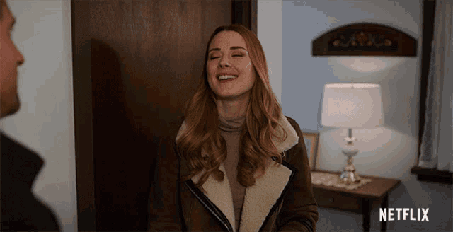 a netflix ad shows a woman laughing in a room