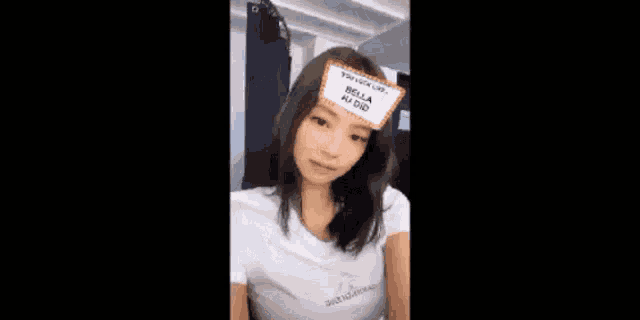a young woman is wearing a name tag on her head .