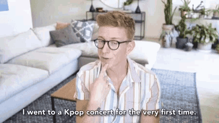 a man wearing glasses is talking about going to a kpop concert