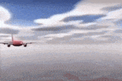 a red airplane is flying through the clouds in the sky .