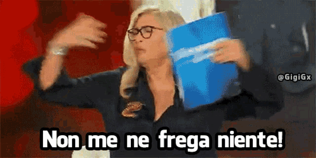 a woman with glasses is holding a blue folder and says non me ne frega niente !
