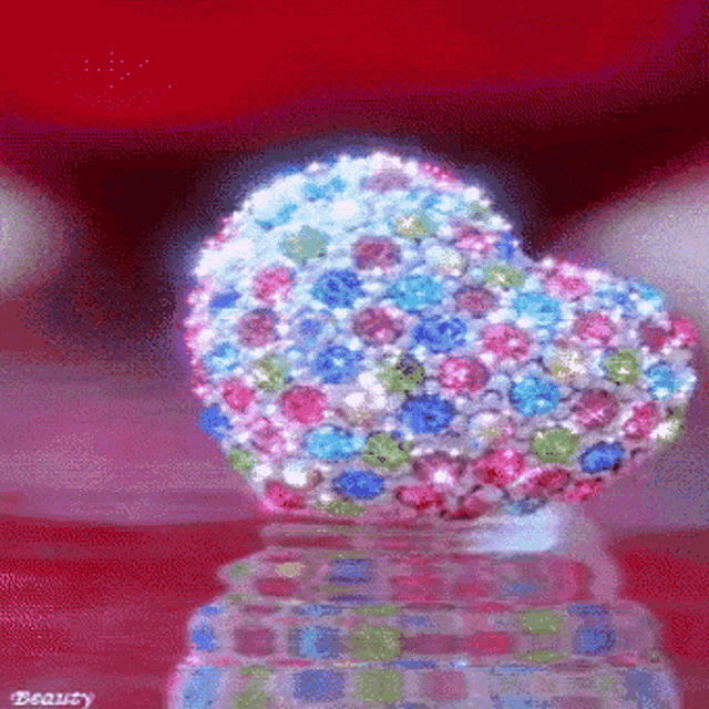 a heart shaped ring with a lot of rhinestones