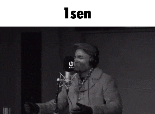 a black and white photo of a man singing into a microphone with the word isen above him
