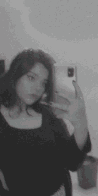 a girl is taking a selfie with her phone