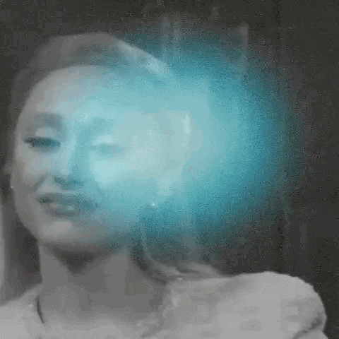 a black and white photo of a woman 's face with a blue light coming out of her head .