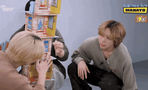 two boys playing a game with a sign that says mamato on it