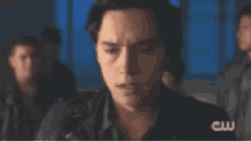 a blurry picture of a man 's face with a cw logo in the corner
