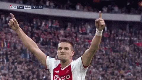 a soccer player giving a thumbs up in front of a crowd .