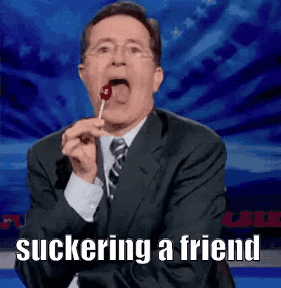 a man in a suit and tie is eating a lollipop and the caption says suckering a friend .