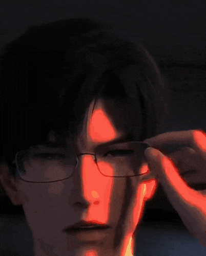 a close up of a man 's face with a dark background