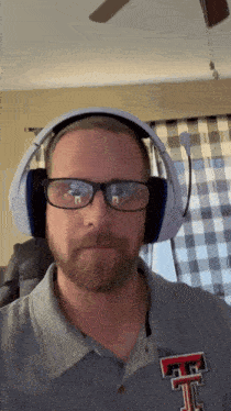 a man wearing headphones and a shirt with the letter f on the front