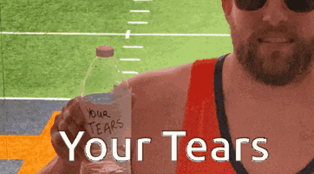 a man is holding a bottle of water that says your tears on it