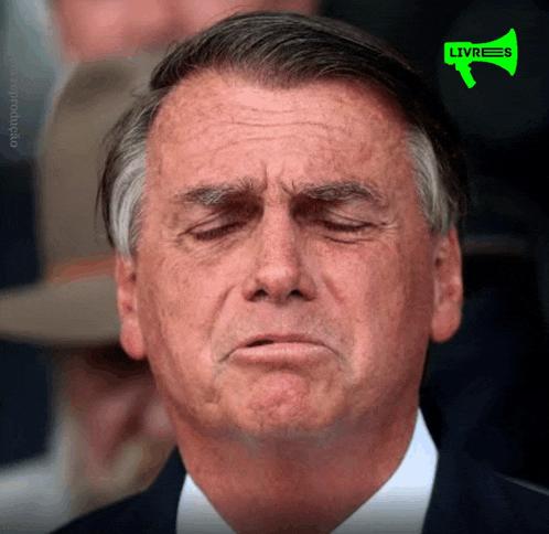 a close up of a man 's face with a green livres sign above him