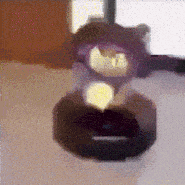a close up of a purple object with a yellow light on it