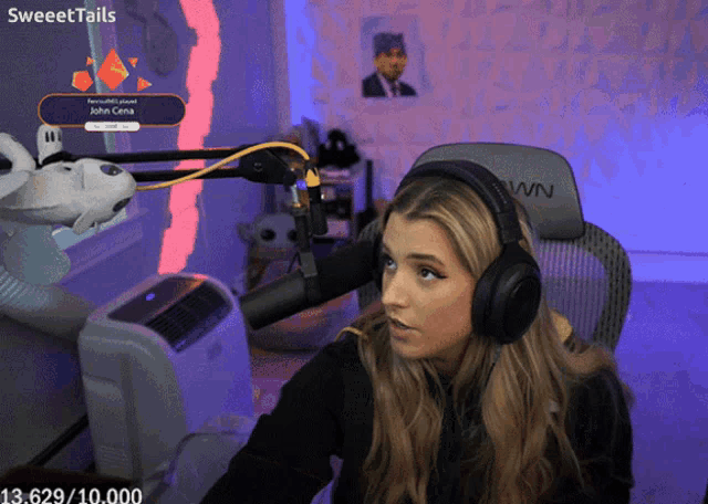a woman wearing headphones sitting in front of a microphone with the words sweettails on the bottom