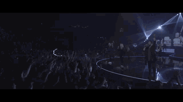 a woman is dancing in front of a screen that says i prophecy