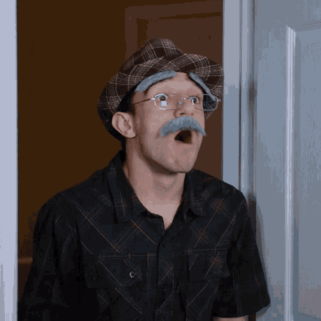 a man wearing glasses and a hat with a mustache looks surprised