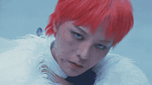 a woman with red hair is wearing a white feathered collar
