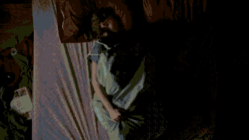 a woman is laying on a bed with a pillow around her waist .