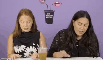 two women are sitting at a table with a potted plant on the wall behind them that says the morning breath .
