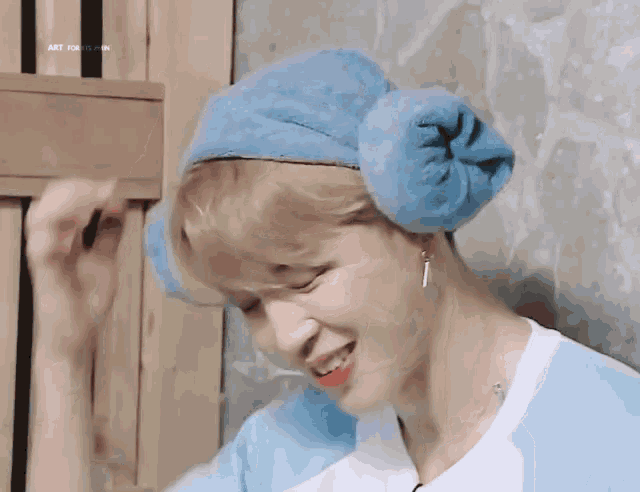 a person wearing a blue towel on their head with the words art focus on the bottom