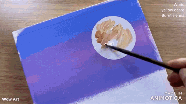 a person is painting a full moon on a blue and purple canvas