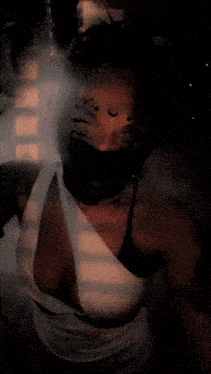 a woman with a snake tattoo on her face and a crescent moon on her face