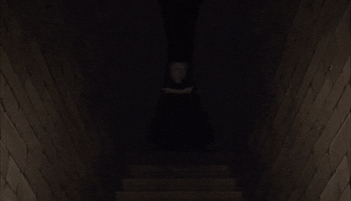 a cartoon drawing of a person covering their face in a dark room
