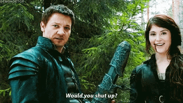 a man and a woman are standing next to each other and the woman is asking the man if he would shut up