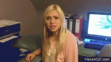 a woman sitting in front of a computer with makeagif.com on the bottom right