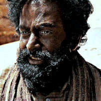 a man with a beard and a scarf around his neck is smiling