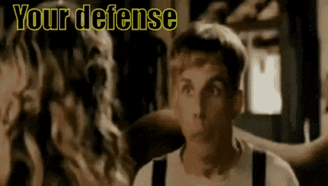 a man is looking up at something with the words your defense behind him