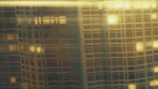 a blurry picture of a building with a lot of windows at night