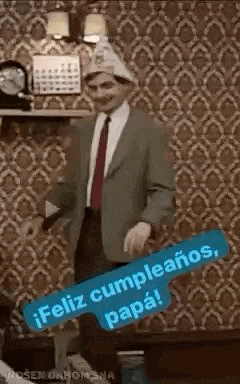 a man in a suit and tie is dancing in a room with a hat on .