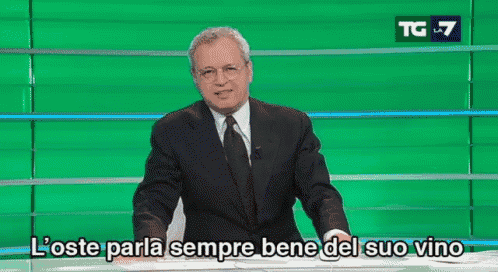 a man in a suit and tie is standing in front of a green screen with the words l' oste parla sempre bene del suo vino