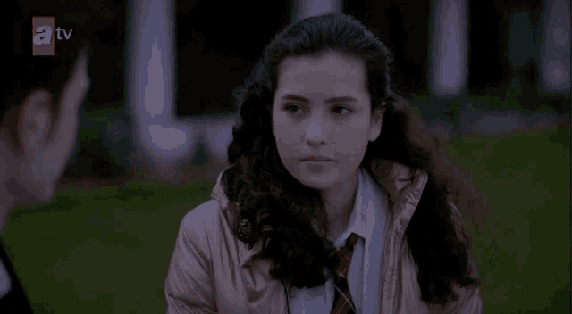 a tv screen shows a girl in a school uniform