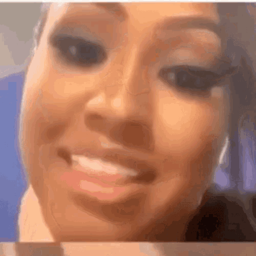 a close up of a woman 's face with a blurred background .