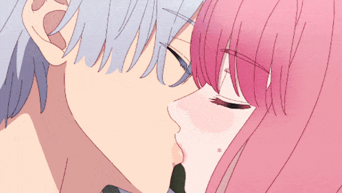 a close up of a man and woman kissing