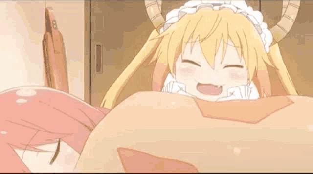 a blonde anime girl with horns is laying on a pink monster 's chest .