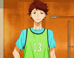 a young man wearing a green jersey with the number 13 on it .