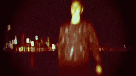 a blurry picture of a man standing in front of a city skyline
