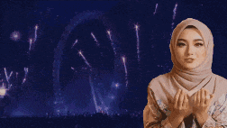 a woman in a hijab is praying in front of a fireworks display that says assalaamuala