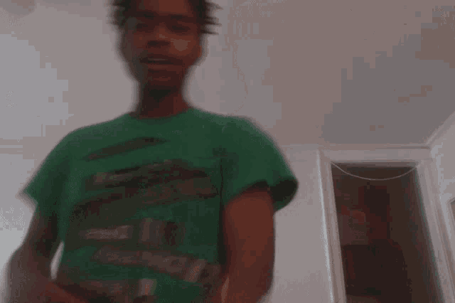 a blurry photo of a man in a green shirt
