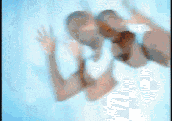 a blurry image of a couple kissing in a pool