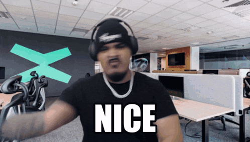 a man wearing headphones and a black shirt with the word nice on it